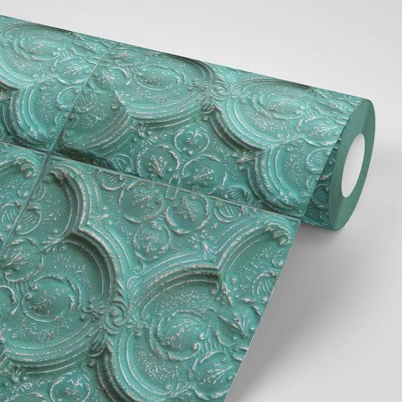 two rolls of green paper with intricate designs on them