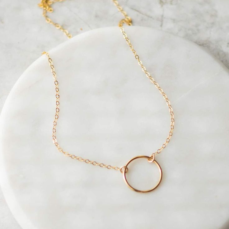 Beautiful 14k gold filled circle necklace that goes with everything. Perfect for everyday wear. Layer it with other gold necklaces or wear it alone. Details: Material: 14k gold filled Length: 16 inches Size: 13mm circle Gold Circle Charm Necklace In Sterling Silver, Minimalist Circle Charm Gold Necklace, Gold Circle Minimalist Charm Necklace, Minimalist Gold Circle Charm Necklace, Everyday Yellow Gold Circle Charm Necklace, Everyday 14k Gold-filled Round Disc Charm Necklaces, Everyday 14k Gold Filled Round Disc Charm Necklace, 14k Gold Jewelry With Delicate Circle Chain, Dainty Circle Yellow Gold Jewelry