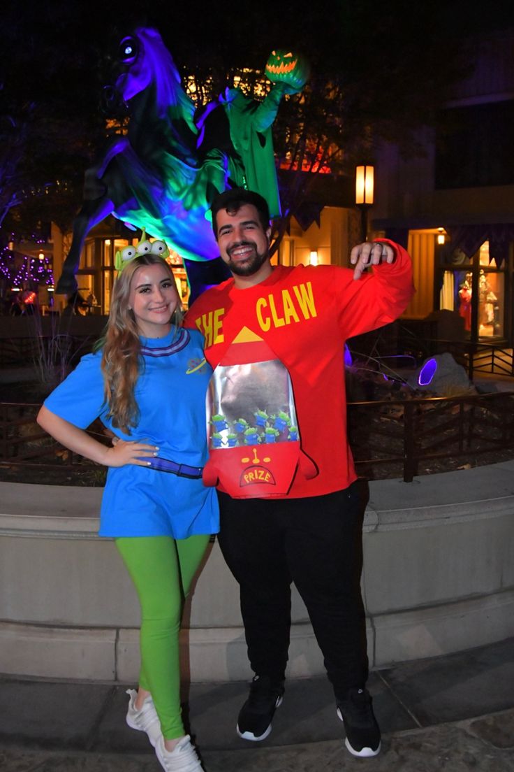 a man and woman in costume posing for a photo at the disneyland california theme park