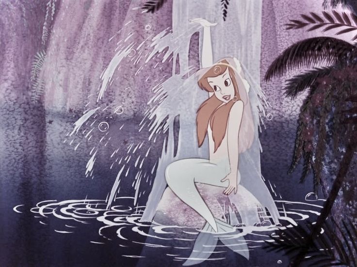 a woman kneeling in the water next to a palm tree