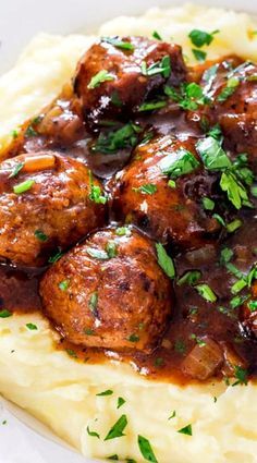 mashed potatoes topped with meatballs and gravy