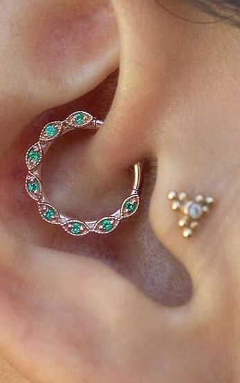 a close up of a person's ear with an ear piercing