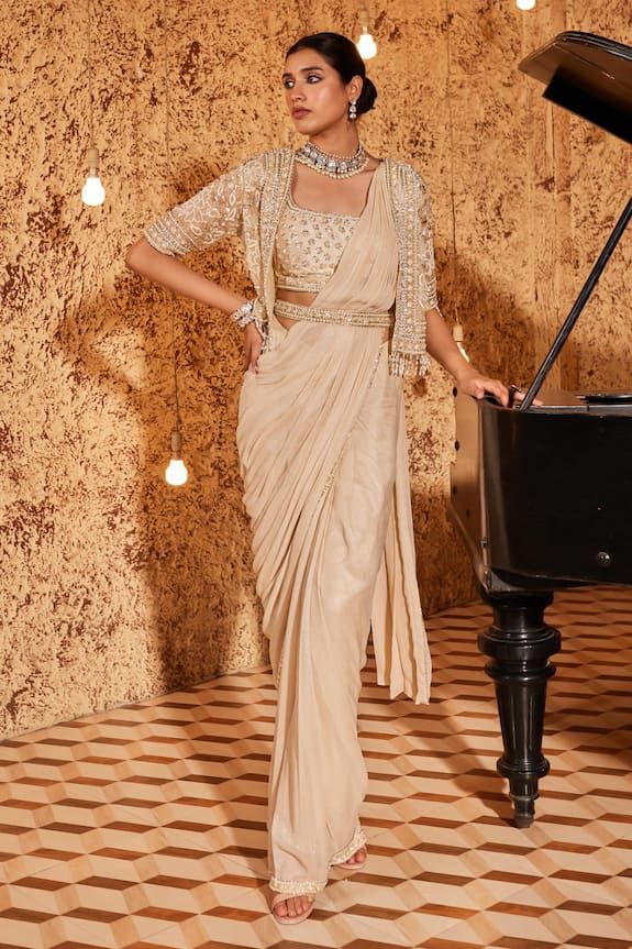 Gold cape with sequin embroidered floral blossom motifs highlighted by pearls. Comes with shimmer base pre-draped saree, padded blouse and belt. - Aza Fashions Party Wear Pre-draped Saree With Cutdana, Designer Party Wear Pre-draped Saree For Eid, Designer Pre-draped Sequin Saree For Diwali, Semi-stitched Sequined Pre-draped Saree For Reception, Eid Party Wear Traditional Blouse Piece, Eid Party Wear Blouse With Traditional Drape, Eid Party Wear Traditional Drape Blouse Piece, Bollywood Sequined Pre-draped Saree In Art Silk, Eid Party Wear Traditional Saree