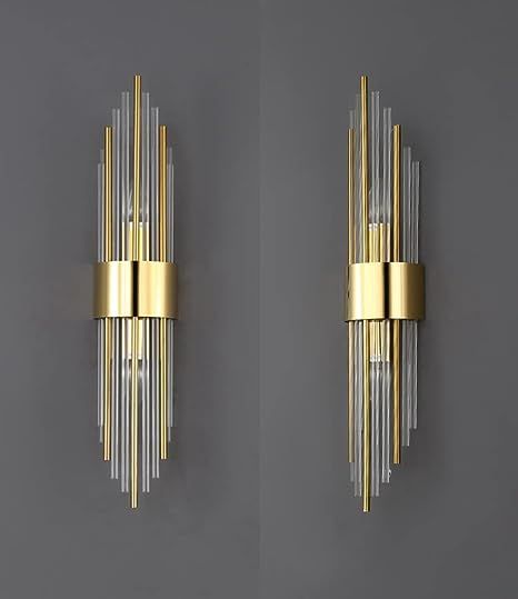 two wall sconces in gold and clear glass on a gray background, each with an individual's own design