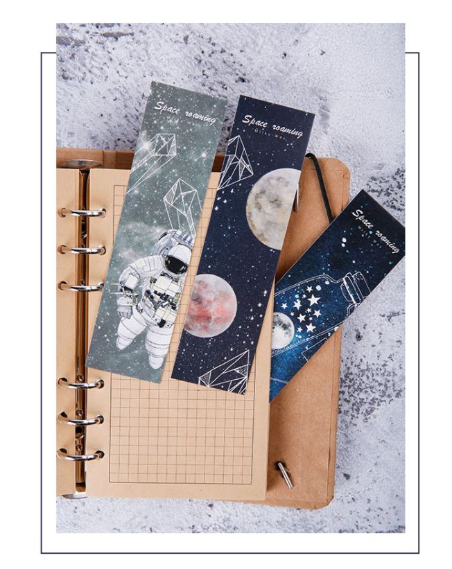 three notebooks with space images on them