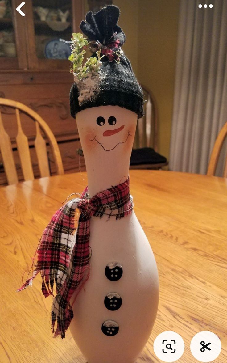 a snowman sitting on top of a wooden table