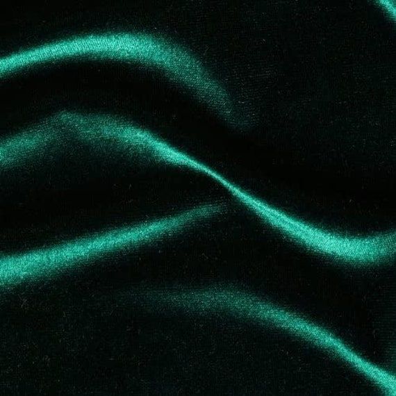 a green fabric with wavy lines on it's surface, as if in the night