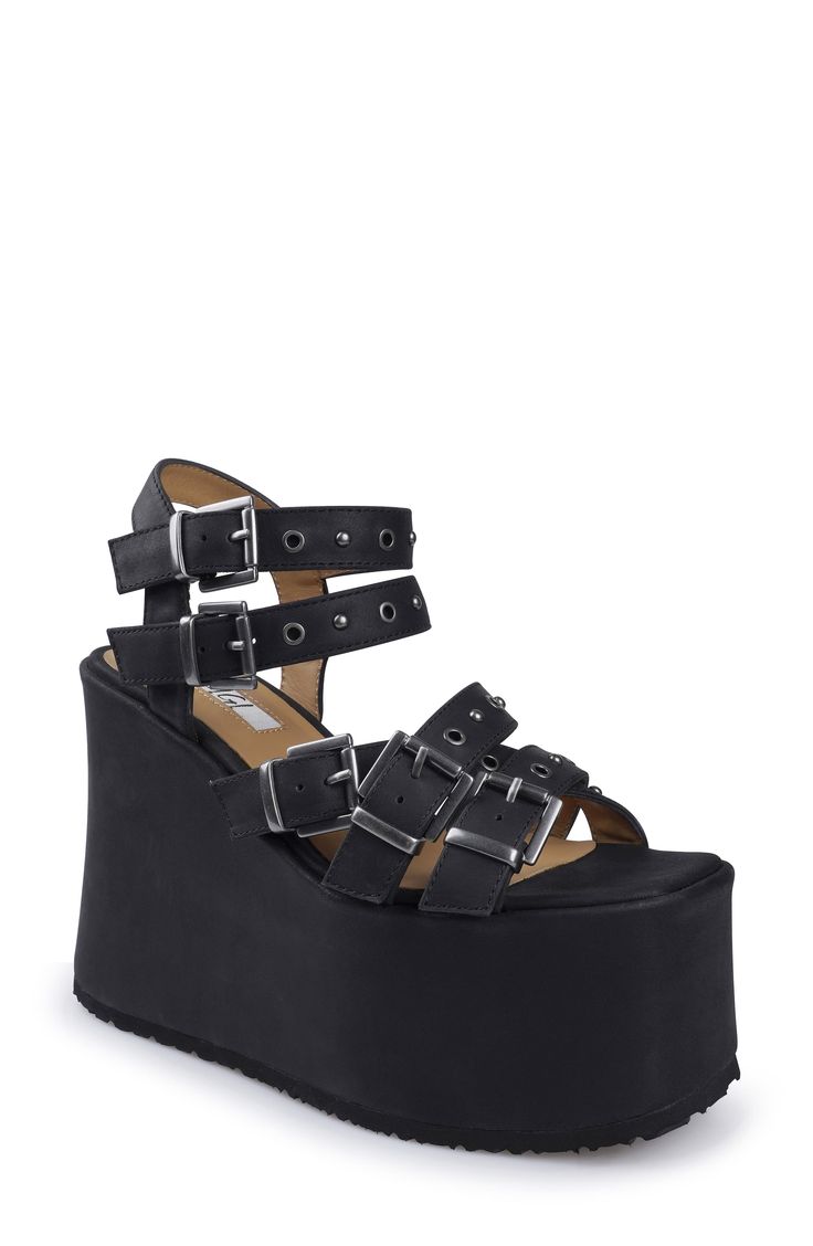 A towering platform and wedge heel ground a strappy leather sandal fixed with adjustable buckles and studs for added edge. 5" heel; 2 1/2" platform Adjustable straps with buckle closures Leather upper and lining/rubber sole Imported Platform Sandals With Round Toe For Concert, Round Toe Platform Sandals For Concert, Punk Style Sandals With Ankle Strap And Buckle, Punk Sandals With Buckle Closure And Ankle Strap, Punk Style Sandals With Ankle Strap And Buckle Closure, Synthetic Double Strap Platform Wedge Sandals, Edgy Sandals With Chunky Platform And Ankle Strap, Platform Open Toe Sandals For Concerts, Platform Heels For Concerts In Synthetic Material