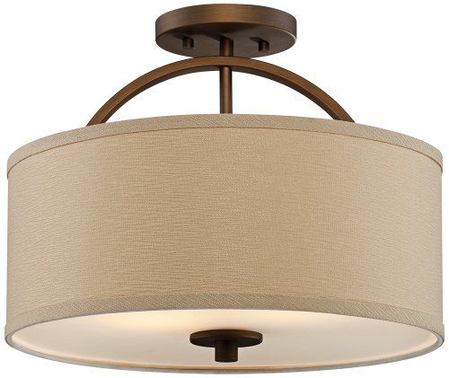 a light fixture with a beige shade on the drum and a white ceiling lamp behind it