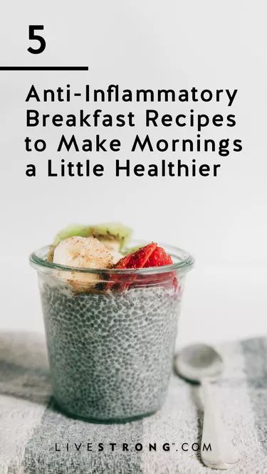 a glass bowl filled with chia seeds and fruit on top of a towel next to a spoon