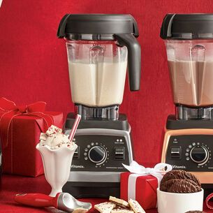 two blenders filled with chocolate and ice cream next to christmas presents on a red background