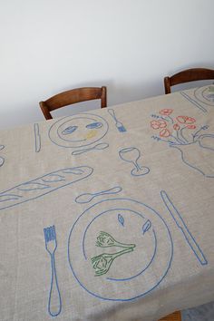 the table cloth has drawings on it