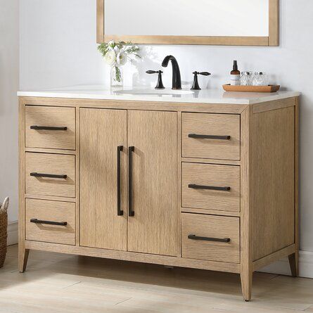 a bathroom vanity with two sinks and a mirror