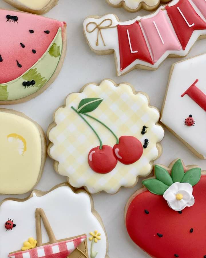 many decorated cookies are displayed on a table