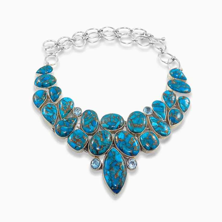 Add a Dash of Exotic! Bring out your Inner Goddess with our stunning Multi Gemstone Turquoise statement necklace handmade in fine sterling silver. Artistically hand-set oval, marquise and pear cut authentic Turquoise gemstones stack artistically in this one-of-a-kind necklace, shimmering all the way. This enchanting necklace will be your favorite addittion to the jewelry box for years to come. Authentic Sivalya Turquoise Hallmarked Metal: 925 Sterling Silver Adjustable Length: 18" - 21" Toggle C Turquoise Statement Necklace, Inner Goddess, Turquoise Gemstone, Necklace Handmade, Pear Cut, Handmade Necklaces, Turquoise Necklace, Jewelry Box, Pear