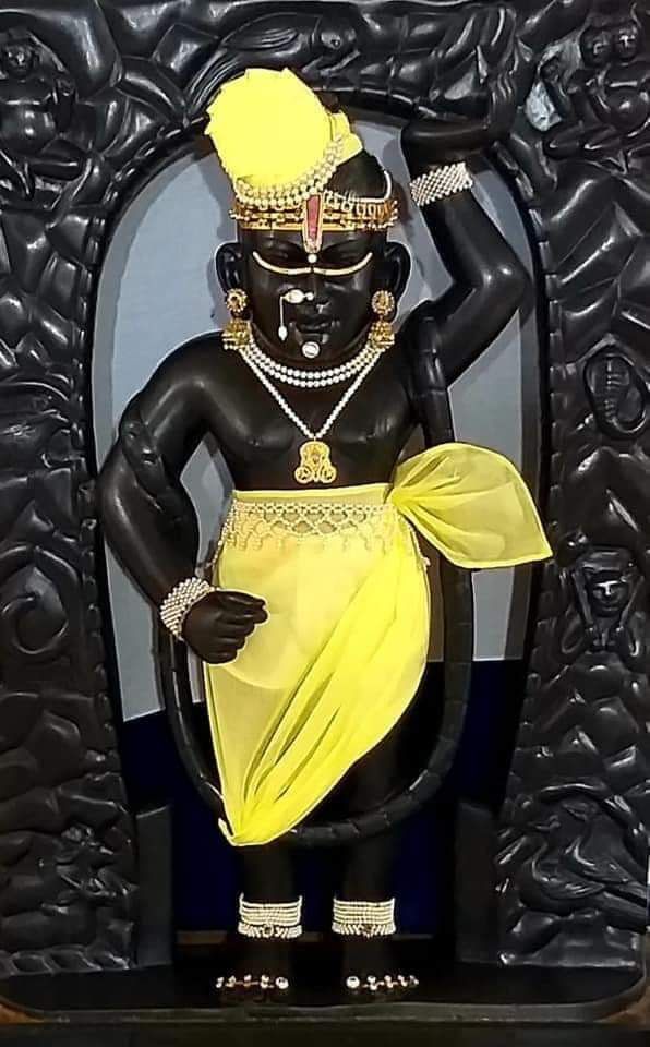 a statue of a person in yellow and black