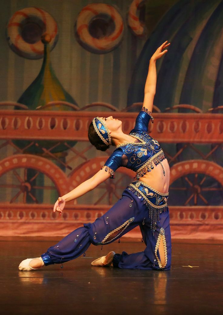 a belly dancer is performing on stage