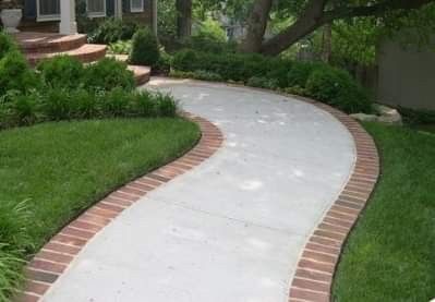 a brick walkway in front of a house