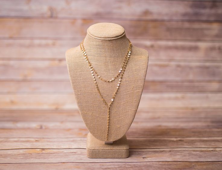 Double Layer Lariat Coin Drop Necklace - Pull off an effortlessly layered look with this beautifully designed necklace. Throw it on with your favorite tee or pair it with your party dress. Matte gold plated over brass for a warm golden finish with a subtle glow. Also available in Silver. 16" - Shorter Layer 18" - Longer Layer with a 2 1/2" drop Lobster Clasp Nickel Free and lead safe Resists tarnishing Handmade with love in Florida Due to the handcrafted nature of our product, all items will var Adjustable Double Strand Layered Necklace For Party, Gold-tone Layered Necklace With Adjustable Chain For Party, Gold Layered Clavicle Chain Necklace For Wedding, Chic Gold Lariat Long Necklace, Gold Lariat Backdrop Necklace For Party, Dainty Adjustable Gold Layered Necklace, Chic Adjustable Gold Long Necklace, Gold Lariat Necklace With Adjustable Chain For Party, Adjustable Gold Chic Long Necklace