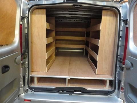 an empty van with its doors open and shelves in the back