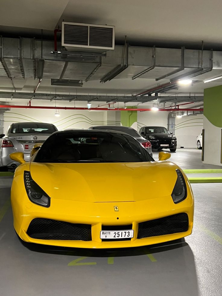 a yellow sports car parked in a parking garage