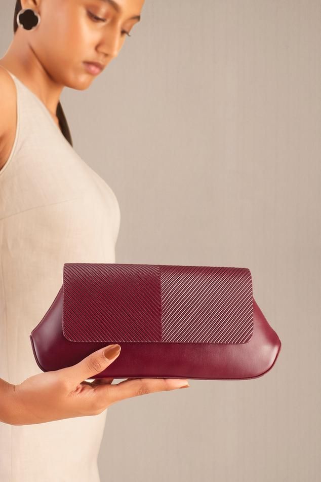 Wine clutch in faux leather base with corded flap.
Composition: 100% PU/Faux Leather
Color: Wine
Other Details: 
Dimensions (in inches): L x W x D: 10 x 1.8 x 4.5
 - Aza Fashions Chic Rectangular Clutch With Leather Lining, Faux Leather Clutch For Travel, Elegant Faux Leather Travel Clutch, Business Leather Clutch, Leather Clutch With Leather Handles, Leather Pouch Clutch With Leather Handles, Leather Evening Clutch With Leather Handles, Leather Clutch With Leather Handles For Evening, Faux Leather Travel Clutch