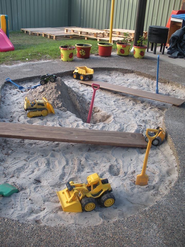 children's play area with toys and construction equipment