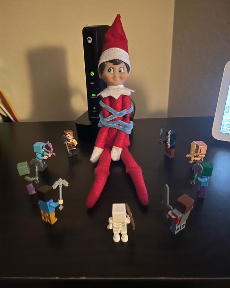 an elf is sitting on top of a desk surrounded by legos