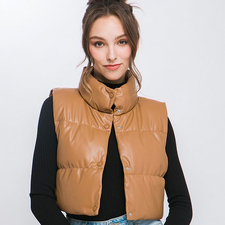 Add a touch of edgy style to your casual outfits with our Faux Leather Puffer Vest. This trendy puffer vest is perfect for layering over your favorite tops. This is a versatile and must-have addition to your casual wardrobe, perfect for staying warm and fashionable during cooler days.Model is 5' 7" wearing a size small. Care Instruction: Machine wash cold, gentle cycle, tumble dry low. Fabric Contents: 100% Polyurethane Non-stretch fabric Non-sheer fabric Size Measurement (inch): S: 14.0 (Bust), Quilted Sleeveless Outerwear For Fall, Quilted Sleeveless Fall Outerwear, Sleeveless Quilted Outerwear For Fall, Trendy Fall Puffer Vest, Trendy Puffer Vest For Fall, Trendy Vest Outerwear, Trendy Fitted Winter Vest, Trendy Sleeveless Puffer Outerwear, Fall Puffer Vest For Streetwear