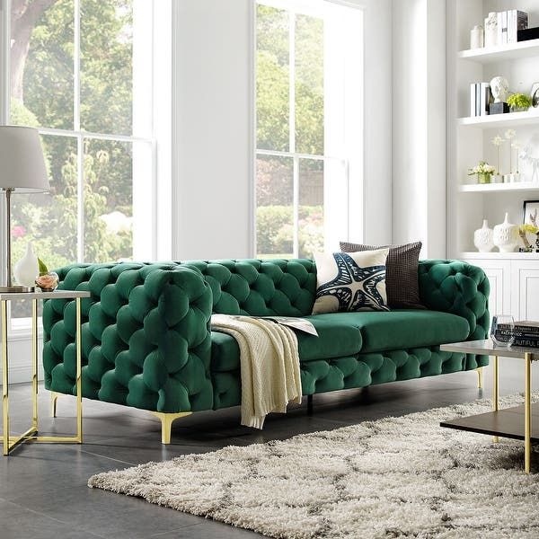 a living room filled with lots of furniture next to a large window and white walls