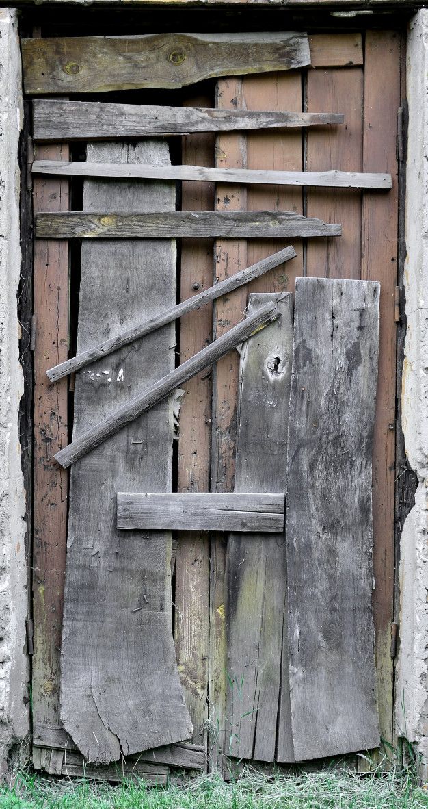 an old wooden door with some tools sticking out of it