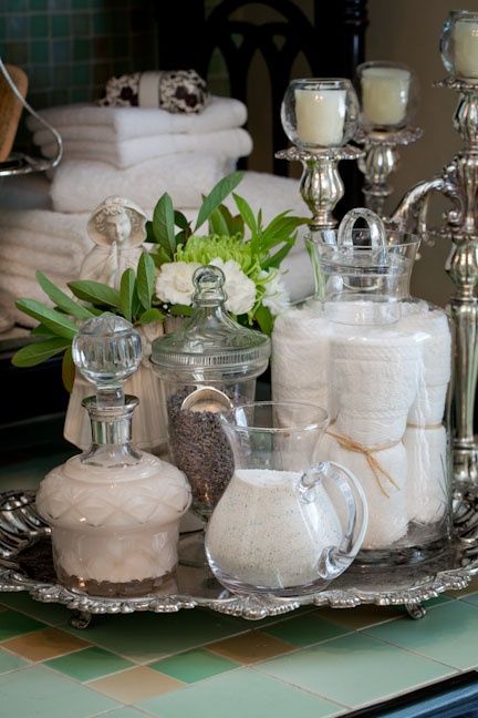 a tray filled with lots of white towels and candles