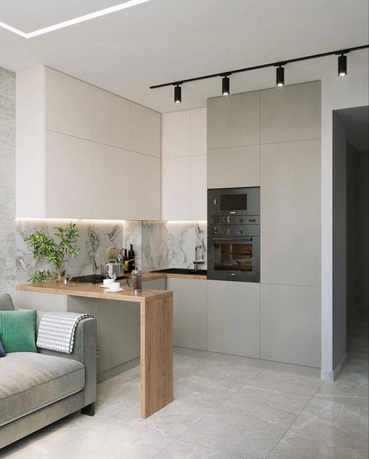 a living room filled with furniture next to a kitchen