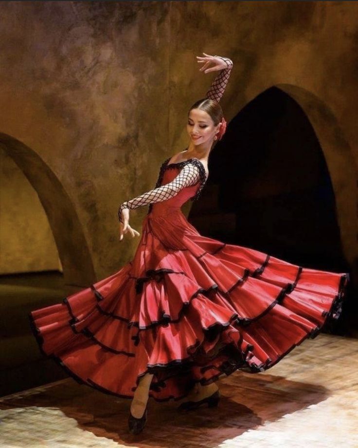 a woman in a red dress is dancing