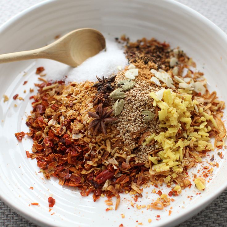 a white bowl filled with spices and seasoning