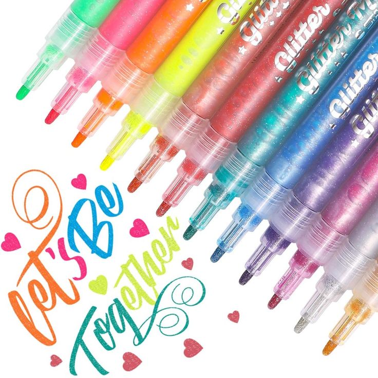 several different colored pens are lined up in the shape of hearts and words that spell out love