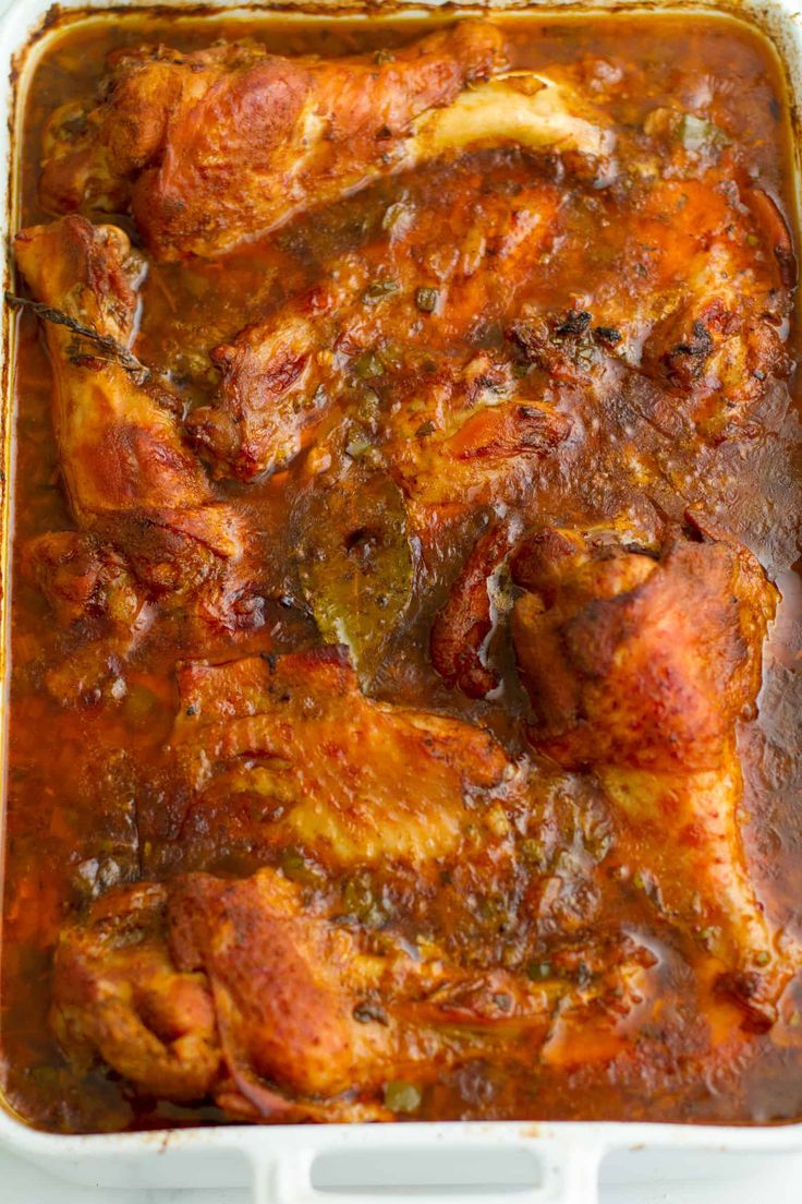 a casserole dish filled with meat and vegetables in gravy, ready to be eaten