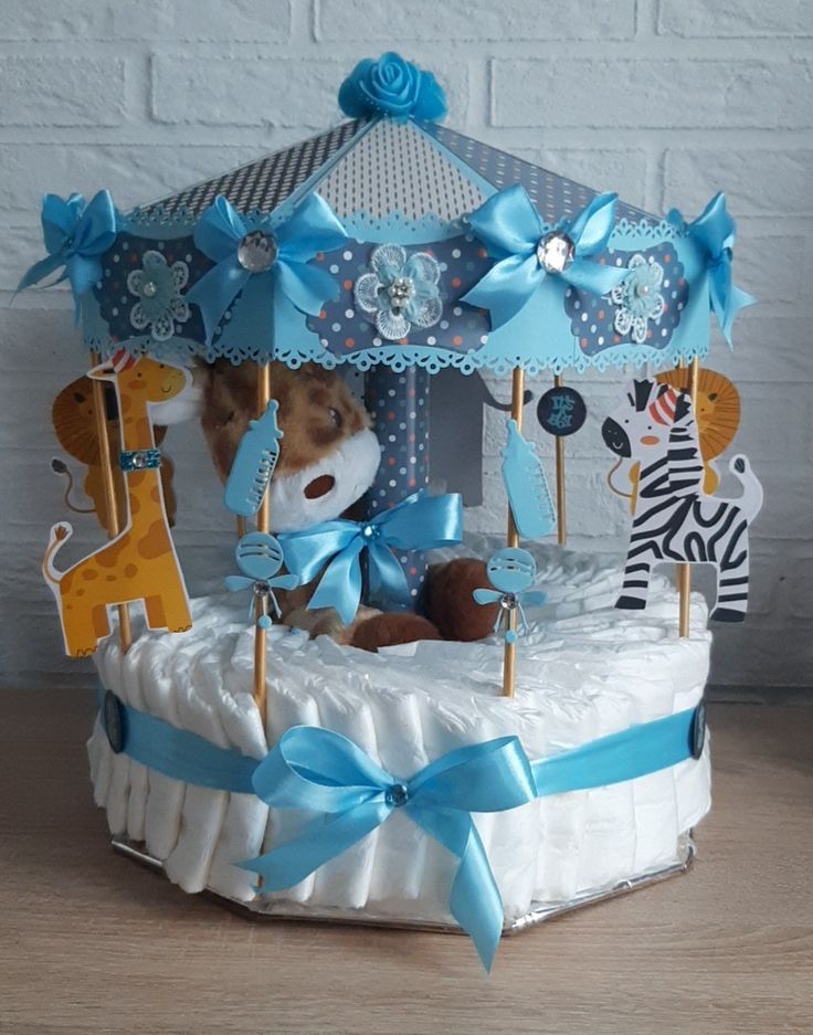 a baby crib made out of diapers with blue bows and giraffes