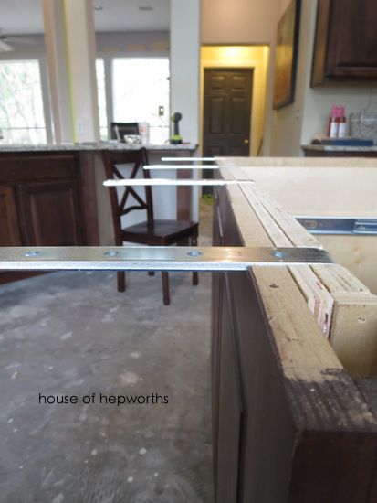 the kitchen counter is being constructed with wood and glass