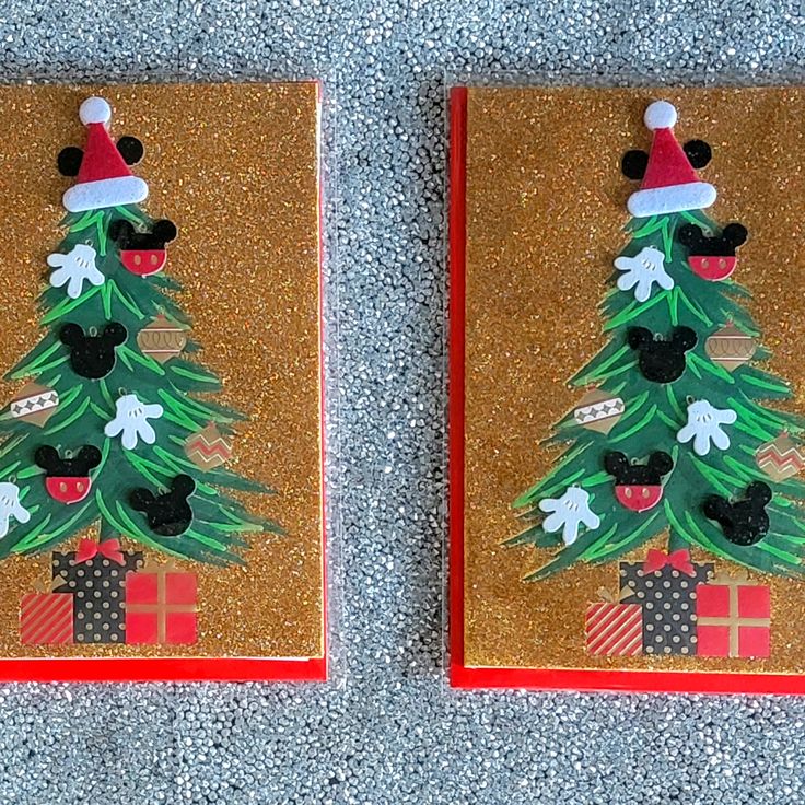 two christmas cards with mickey mouse on top and a christmas tree on the bottom, both decorated in gold glitter