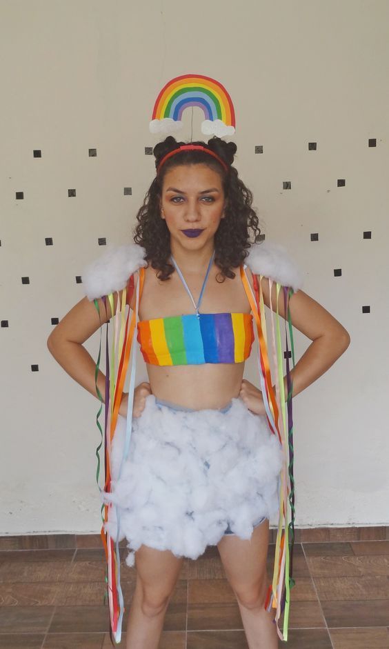 a woman in a rainbow outfit with her hands on her hips