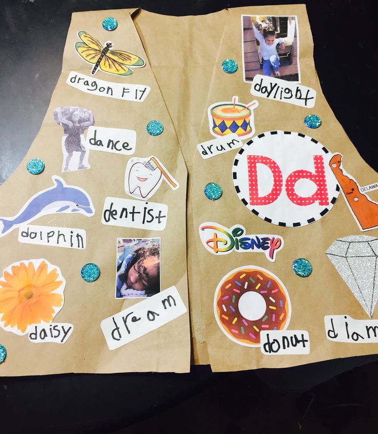 two brown paper bags with different stickers on them, one has the letter d and the other has pictures of people