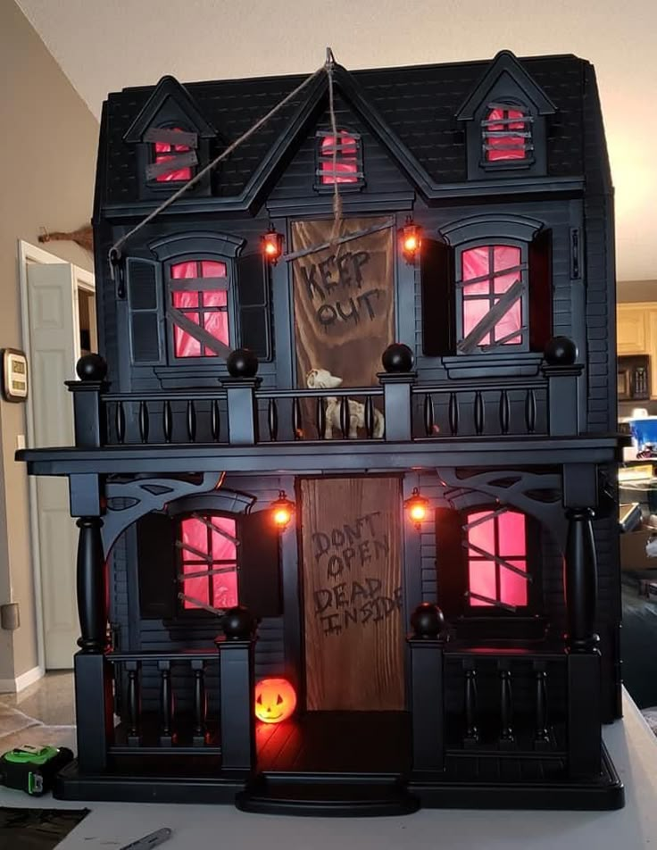 a black doll house with red lights on it