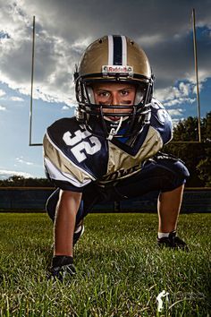 a football player kneeling down in the grass