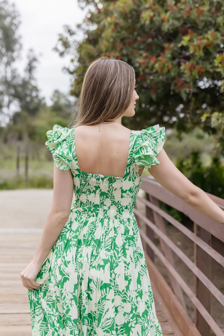 Embrace the beauty of the Bree Maxi Dress, featuring a stunning floral print and elegant green hue. The ruffle sleeves and V neck line create a timeless yet trendy look, perfect for any wedding season. Details + Fit 100% Polyester Runs True to Size Hand Wash Cold Hang Dry V Neckline Ruffle Sleeves Pleated Chest Back Zipper Closure Smocked Back Tiered Skirt Flowy Lined Floral Print Design Green | Multi | Printed Model is 5’6” and wearing a size Small Green Flutter Sleeve Dress With Ruffle Hem, Vacation Floral Dress With Square Neck And Ruffles, Vacation Floral Dress With Ruffles And Square Neck, Green Ruffled Straps Vacation Dress, Green Vacation Dress With Ruffled Straps, Green Floral V-neck Dress With Ruffles, Green Dress With Ruffle Hem And Ruffle Sleeves, Green Dress With Ruffle Hem And Sleeve, Green Flutter Sleeve Dress For Vacation