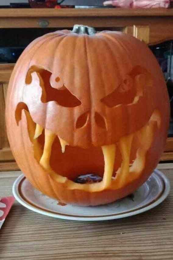 a carved pumpkin sitting on top of a plate