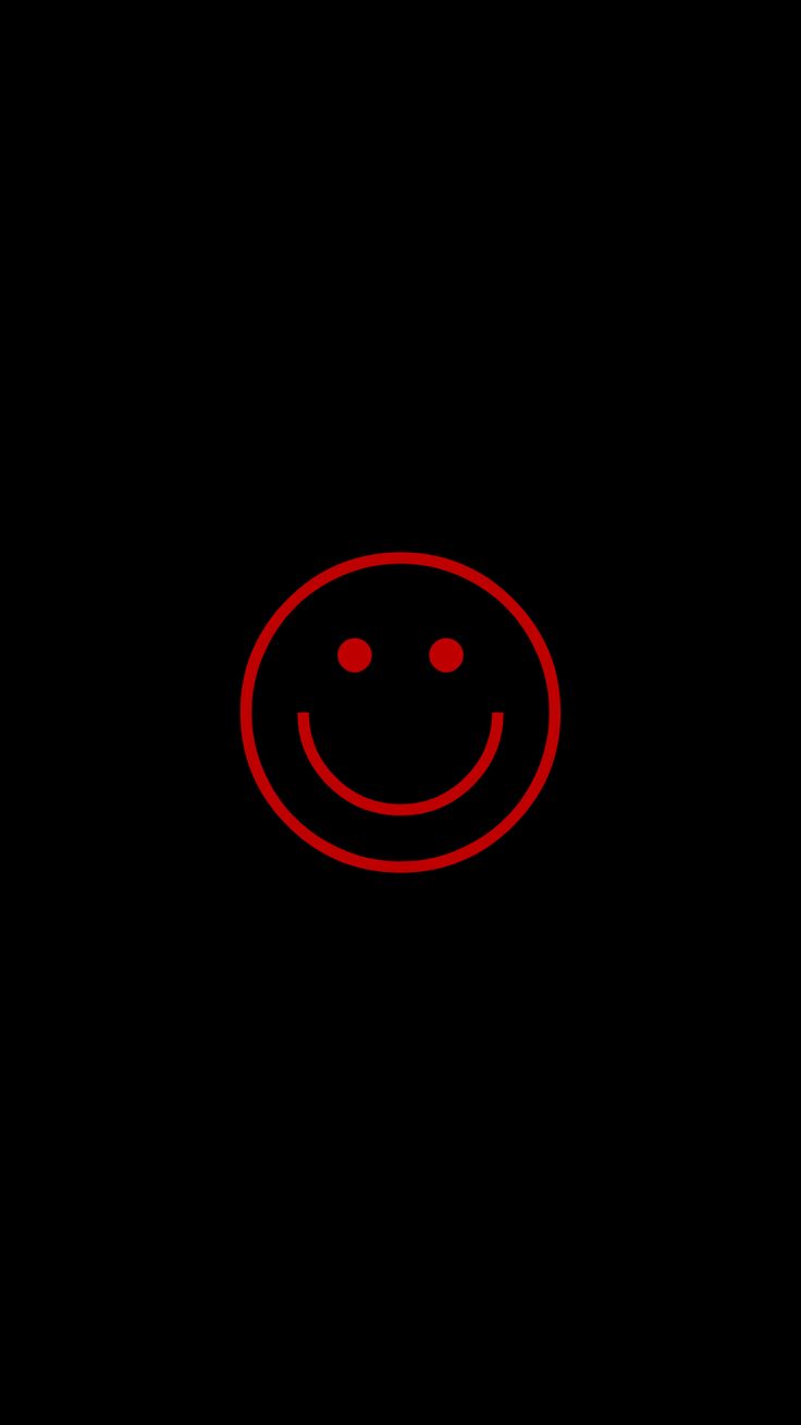 a red smiley face on a black background