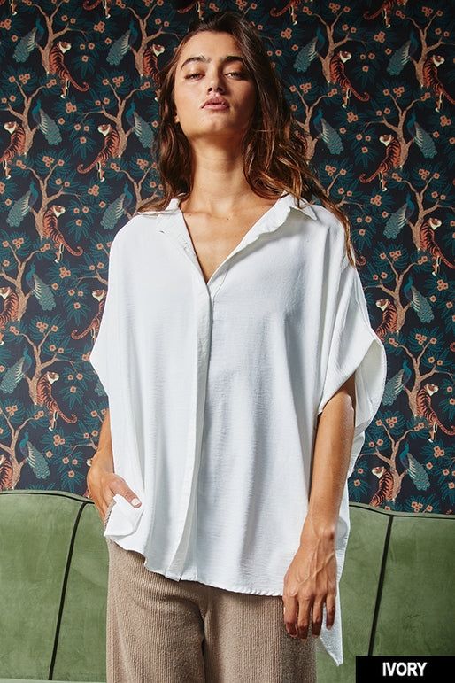 Stay comfortable and stylish in our Oversized Dolman Top. Featuring a collared button-down front and short drop-shoulder sleeves, this loose-fitting top is perfect for any occasion. Its curved hi-low hemline and textured lightweight woven fabrication add unique details to this must-have shirt. • Fabric: 100%POLYESTER First model wearing a medium 5'4 Fall Staples, Dolman Top, Dolman Sleeve Tops, Oversized Blouse, Loose Fitting Tops, Oversized Shirt, Quality Fashion, Dolman Sleeve, Shoulder Sleeve