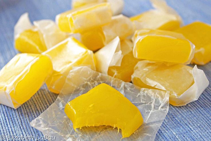 pieces of yellow fruit sitting on top of plastic wrap