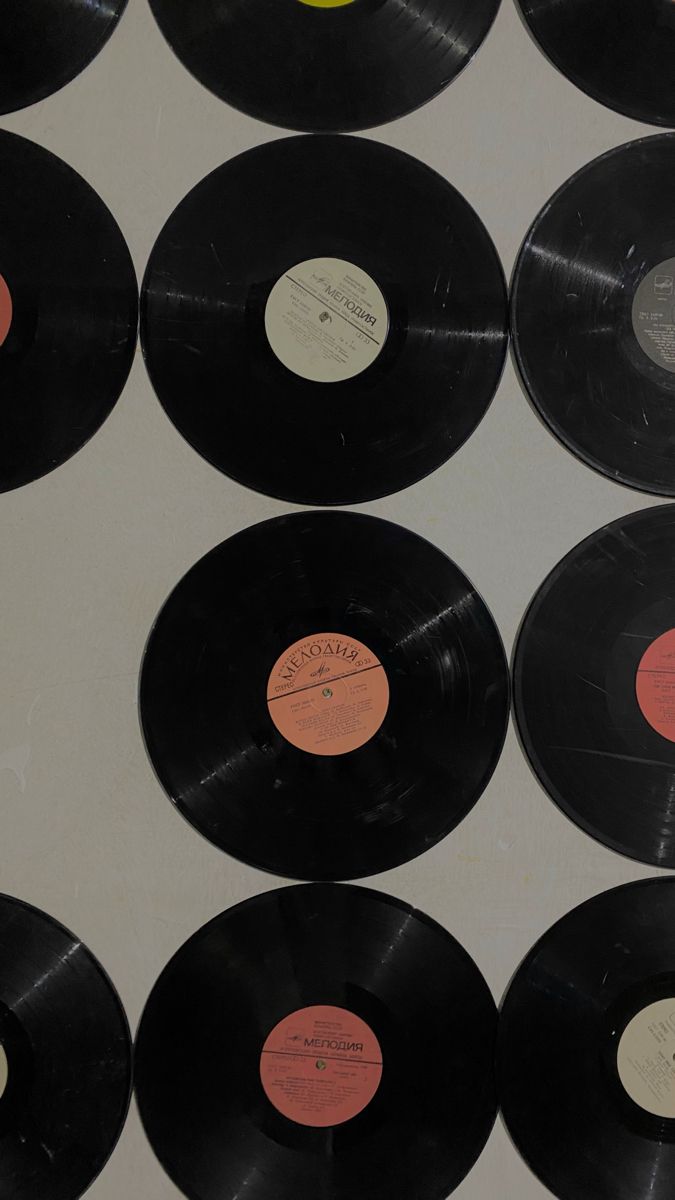 many black and red records are lined up together